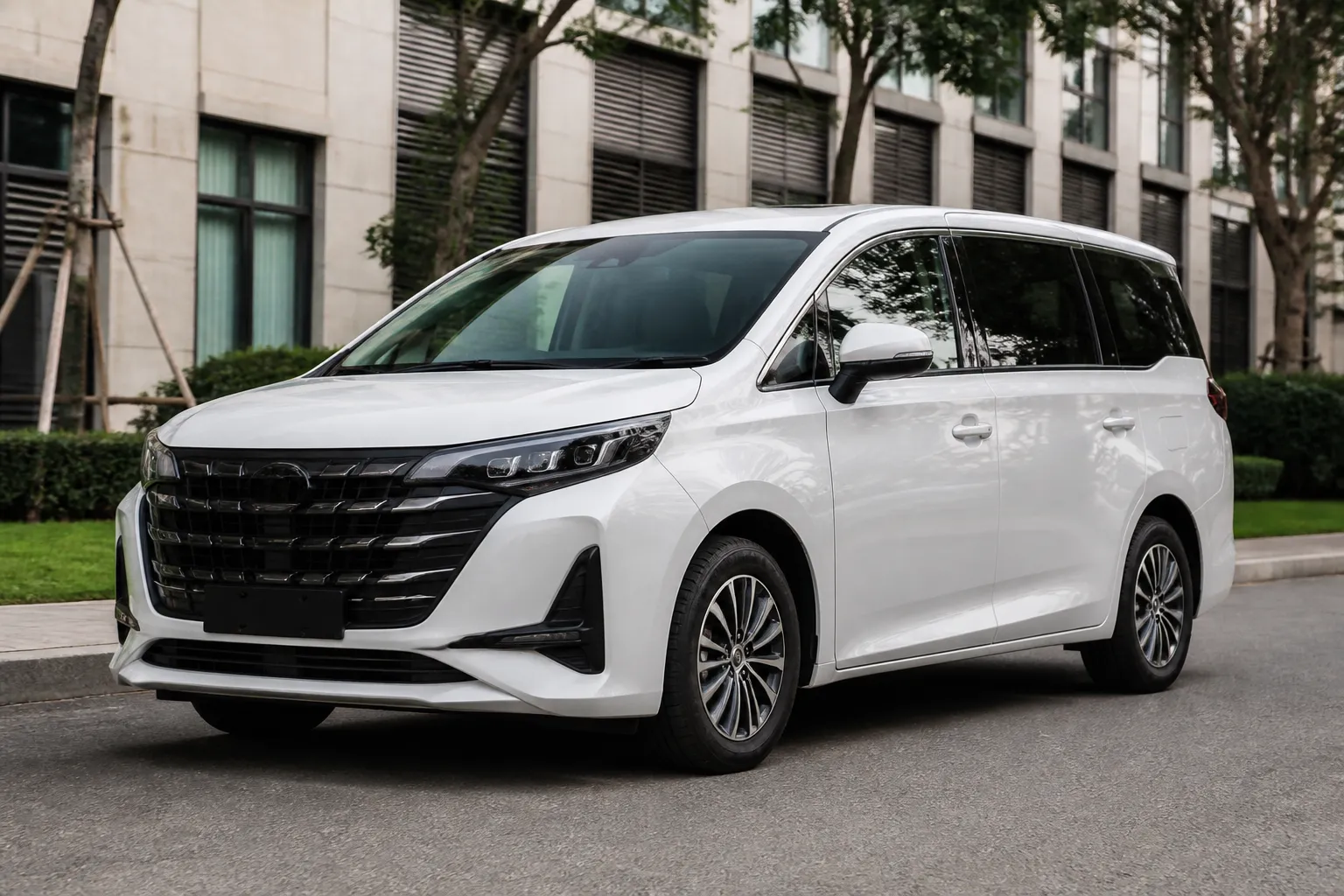 GAC Trumpchi M6 на городской улице, семейный минивэн снят спереди под углом в естественном дневном свете.